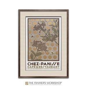 May include: A framed poster with a gold honeycomb pattern and a stylized floral design in shades of brown and green. The text "CHEZ PANISSE CAFE & RESTAURANT" is printed in black at the bottom of the poster, along with the address and phone number.