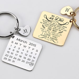 May include: A silver keychain with a calendar charm that reads "March 2015" and a gold keychain with a heart charm that reads "W" and a rectangular charm with the text "To My Dad So much of me is made from what I learned from you. No matter how far I go in life you will always be the man that I will look up to. You're the greatest! I love you always & forever."