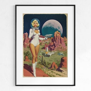 May include: A framed vintage-style print depicts a woman in a white spacesuit and helmet, holding a ray gun, set against a backdrop of a desert landscape, a large moon, and spaceships. The artwork has a retro sci-fi aesthetic.
