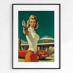 May include: Framed vintage-style print featuring a woman holding a gun, set against a retro backdrop. The artwork showcases a woman in a white turtleneck and orange skirt, with a red car and a mid-century modern house. The background is a teal green.