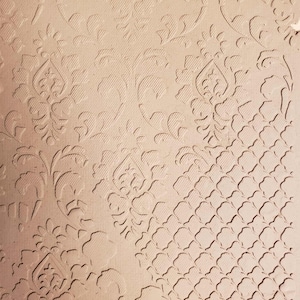 May include: A beige paper with an embossed floral and geometric pattern. The design features detailed, repeating floral motifs and a lattice-like pattern, creating a textured surface. The paper has a subtle, neutral color.
