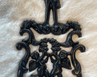 CAST IRON Trivet…cupid Motif…cherubs Holding a Wreath CAST IRON Trivet…cupid Motif…cherubs Holding a Wreath
