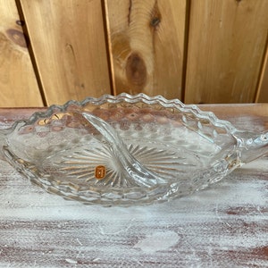 May include: A clear glass serving dish with two handles. The dish has a scalloped edge and a diamond pattern. The dish is made by the company "51" and is in good condition.