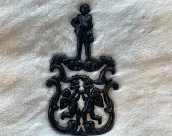 CAST IRON Trivet…cupid Motif…cherubs Holding a Wreath CAST IRON Trivet…cupid Motif…cherubs Holding a Wreath