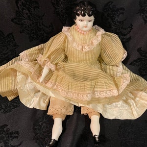 PORCELAIN CHINA DOLL…Porcelain Head, Arms and Legs…Soft Body…Marked “L.S.T.L 1-66”…Handmade/Handpainted…Slip, Layered Dress/Stand #000bx3