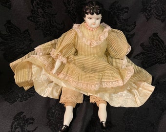 PORCELAIN CHINA DOLL…Porcelain Head, Arms and Legs…Soft Body…Marked “L.S.T.L 1-66”…Handmade/Handpainted…Slip, Layered Dress/Stand #000bx3