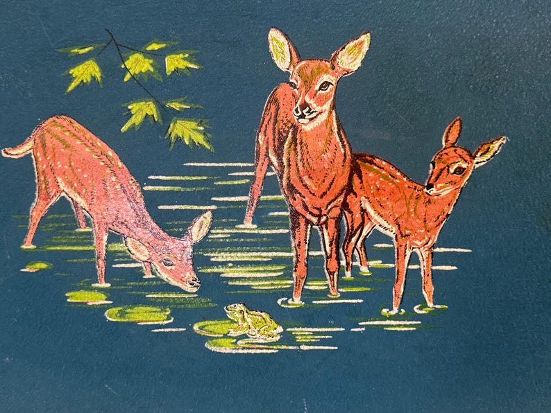 May include: A vintage illustration depicts three deer standing in water with lily pads and a frog. The deer are various shades of brown and pink, set against a dark blue background. Green leaves are in the upper left corner.