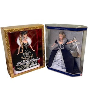 May include: Two Barbie dolls in their original boxes. One is the 2006 Holiday Barbie, in a black gown with gold and teal accents. The other is the Millennium Princess Barbie, in a navy and silver gown.