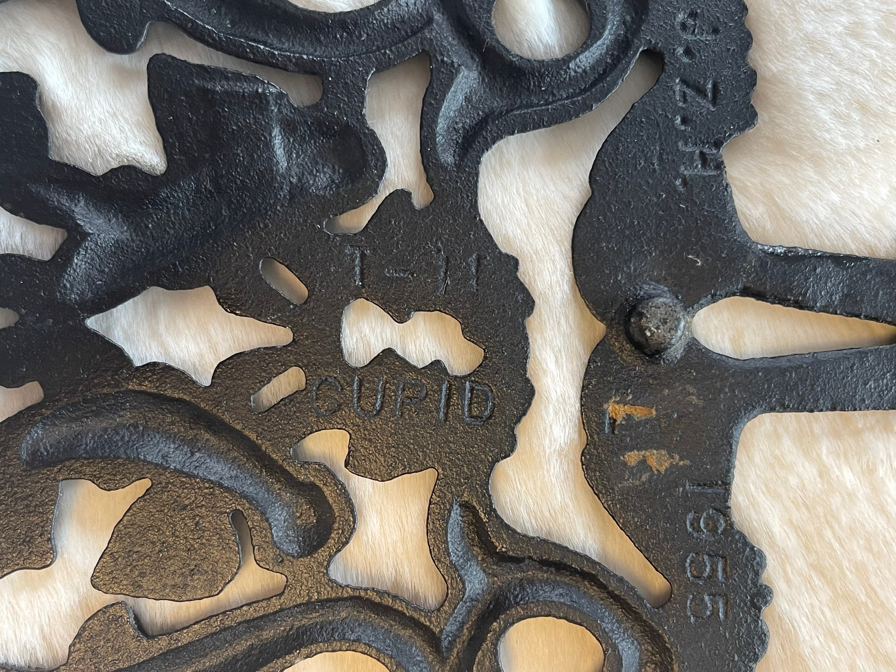 CAST IRON Trivet…cupid Motif…cherubs Holding a Wreath CAST IRON Trivet…cupid Motif…cherubs Holding a Wreath