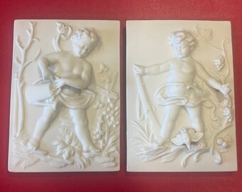 CHERUB WALL PLAQUES…Arnart… Bisque Porcelain…Cherub Wall Art…Cherub with Watering Can/Hunting Cherub…Nature…Hanging Holes…Vintage…Japan #934