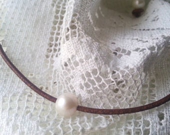 Single pearl necklace and leather