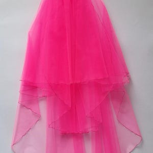 May include: A bright pink bridal veil with multiple layers of sheer fabric. The veil is gathered at the top and cascades down, featuring a scalloped edge. The text "MikelinaArt" is visible at the bottom right.