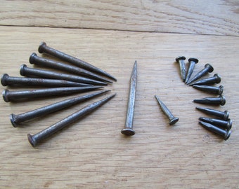 Small hand forged iron split nail for wood with ring for hitching hanging objects vintage architectural salvage for restorations