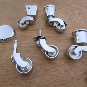 May include: Set of chrome furniture casters with a variety of styles, including swivel and fixed options. The set includes a screw, a round plate, and a cap.