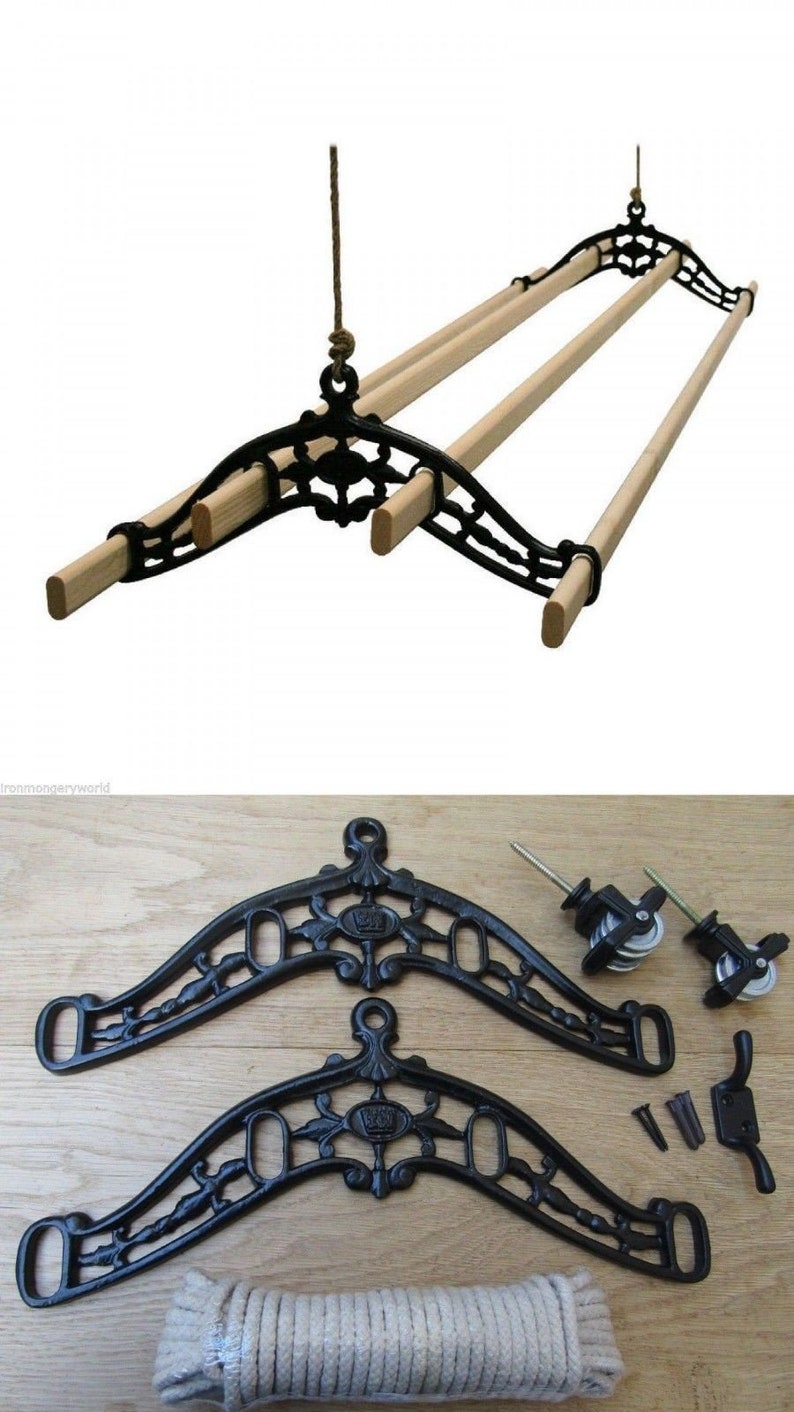May include: A black cast iron clothes drying rack with wooden dowels, suspended by a rope. The rack is shown with its components, including decorative brackets, pulleys, rope, and mounting hardware. A vintage-style laundry solution.