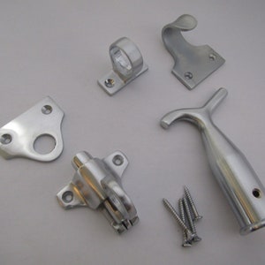 May include: A set of silver-toned window hardware, including a hook, a latch, a hasp, a sash lift, and screws.