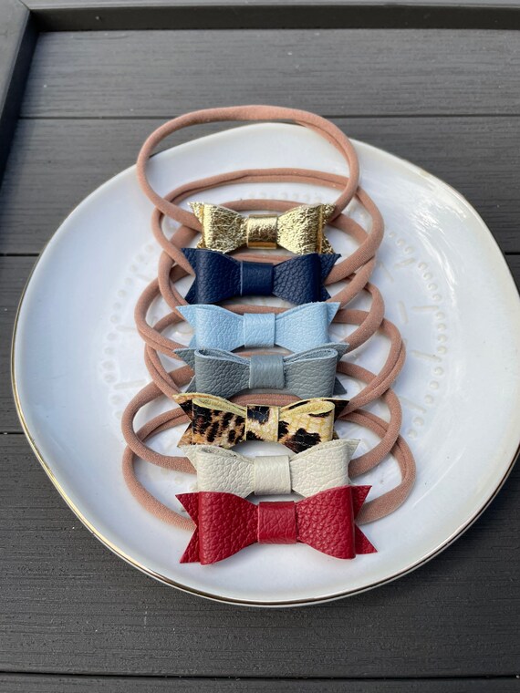 Mini Leather bows on nylon headbands. Your Choice of color.