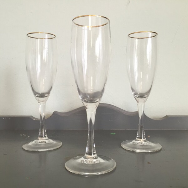 Three Champagne Flutes with Gold Rim