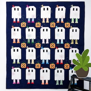 May include: A navy blue Halloween quilt featuring white ghost figures with colorful legs and small pumpkins. Each ghost has a flower and a small bow. The quilt is a patchwork design.