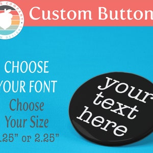 May include: Custom buttons with a black button featuring the text "your text here" in white. The buttons are available in two sizes: 1.25 inches or 2.25 inches.