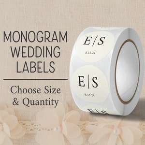 May include: Roll of white round wedding labels with black text. The labels feature the monogram "E/S" and the date "8.13.24". The text "Monogram Wedding Labels" and "Choose Size & Quantity" is visible above the roll of labels.