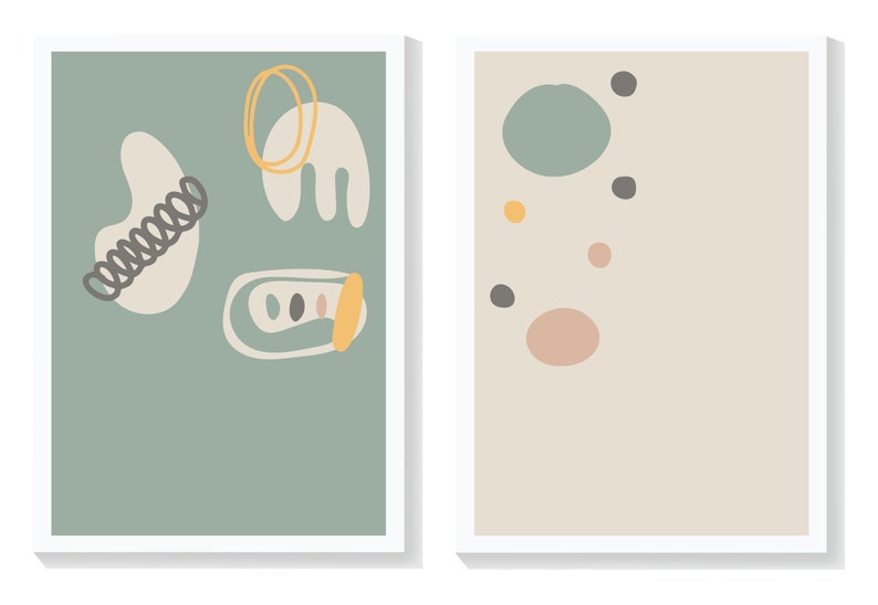 May include: Two framed abstract art prints with a minimalist design. The print on the left has a light green background with white, yellow, and black abstract shapes. The print on the right has a light beige background with various sized circles in shades of green, pink, yellow, and black.
