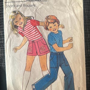May include: Vintage sewing pattern for shorts and trousers, featuring illustrations of children's clothing. The pattern includes the text "SPECIAL OFFER PATTERN" and "Shorts and Trousers". Sizes available are 2/3, 3/4, 5/6, and 7/8 years.
