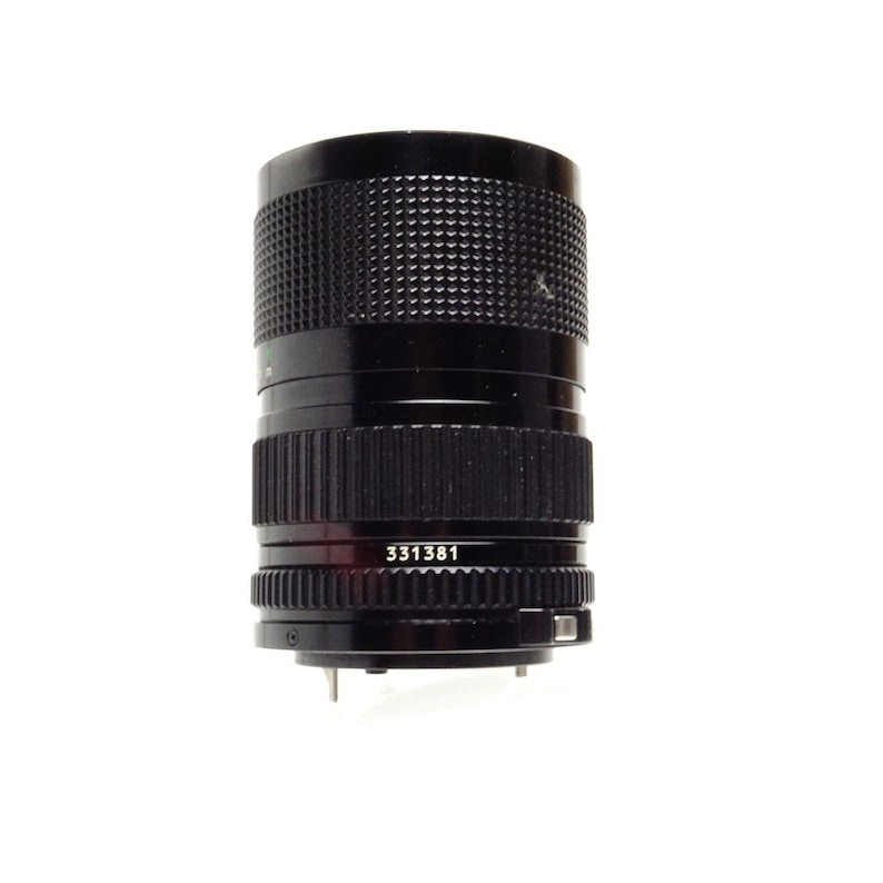 May include: A black Canon camera lens with a silver ring and the number 331381 printed on it.