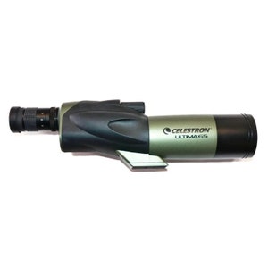 May include: A Celestron Ultima 65 spotting scope. The scope has a black and olive green body with a black eyepiece and a silver-colored angled piece. The Celestron Ultima 65 logo is printed on the side.