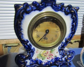 Gilbert 'May' Flow Blue China Case Clock  Measures 7.75 X 6.5 X 3 Inches.