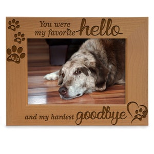 May include: A wooden picture frame with a photo of a dog inside. The frame has the text "You were my favorite hello and my hardest goodbye" engraved on it.