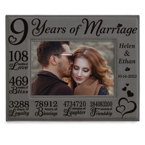 May include: A gray leather picture frame with a photo of a couple. The frame is engraved with the text "9 Years of Marriage" and the couple's names, "Helen & Ethan", along with the date "10-14-2022". The frame also includes the number of months, weeks, days, hours, minutes, and seconds that the couple has been married.