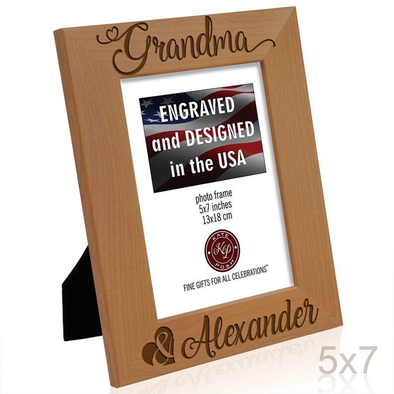 May include: A wooden picture frame with the words "Grandma & Alexander" engraved on it. The frame is 5x7 inches and has a small heart symbol next to each name. The frame is made in the USA.