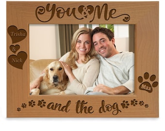 May include: A wooden photo frame with the text "You & Me and the dog" engraved on it. The frame has two hearts with the names "Trisha & Nick" engraved on them and a paw print with the name "Max" engraved on it.