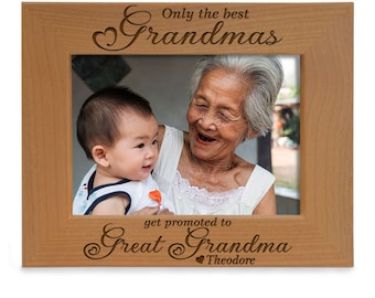 May include: A wooden picture frame with a photo of a grandmother and a baby. The frame has an engraved message that reads "Only the best Grandmas get promoted to Great Grandma Theodore."