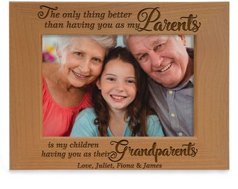 May include: A wooden picture frame with a photo of three people smiling. The frame has an engraved message that reads "The only thing better than having you as my Parents is my children having you as their Grandparents. Love, Juliet, Fiona & James."