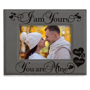 May include: Gray picture frame with a couple in a photo. The frame has the text "I am Yours" and "You are Mine" with hearts. The names Mark and Lillian are also included in the frame.