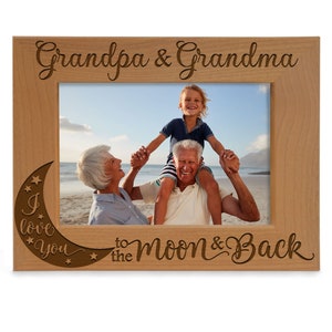 May include: A wooden picture frame with the words "Grandpa & Grandma" engraved at the top. The frame has a crescent moon design with stars and the words "I love you" and "to the moon & back" engraved on the bottom.