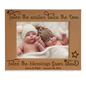May include: A wooden photo frame inscribed with the words "Twice the smiles, Twice the love, Twice the blessings from above". The frame also includes the names "James & Elijah" and the date "January 22, 20xx". The frame features a photo of two babies wearing knitted hats.