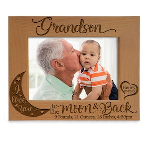May include: A wooden photo frame with the words "Grandson I love you to the moon & back" engraved on it. The frame also includes the text "Henry 09-28-xx" and "9 Pounds, 11 Ounces, 18 Inches, 4:30pm".