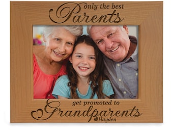 May include: A wooden picture frame with a photo of a family of three. The frame is engraved with the text "Only the best parents get promoted to grandparents Hayden".