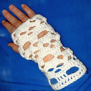 May include: White crocheted fingerless gloves with a skull design.