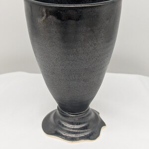 May include: A set of three ceramic mugs with a speckled, matte finish. The mugs are in shades of cream, light gray, and dark gray. Each mug has a simple, minimalist design, perfect for coffee or tea.