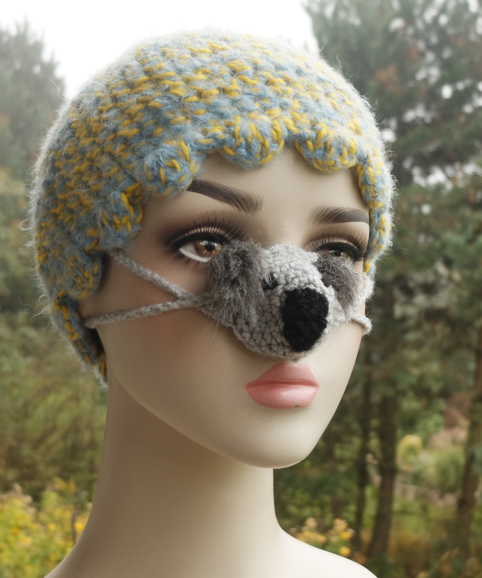 mannequin wearing a nose warmer shaped like a koala bear