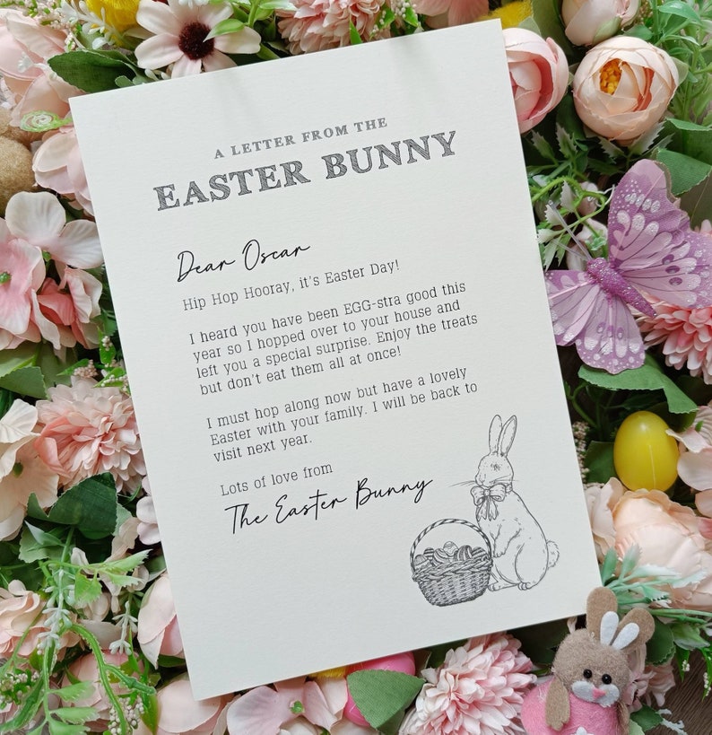 May include: A cream-colored letter from the Easter Bunny, with text and a bunny illustration. The letter is surrounded by pink and yellow flowers, a purple butterfly, and a small Easter bunny figurine.