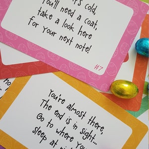 May include: A set of nine Easter egg hunt clue cards with a pink, orange, yellow, and green background. Each card has a different number and a clue written on it. The clues are: "When it's cold, you'll need a coat, take a look here for your next note!" and "You're almost there, the end is in sight... Go to where you sleep at night!"
