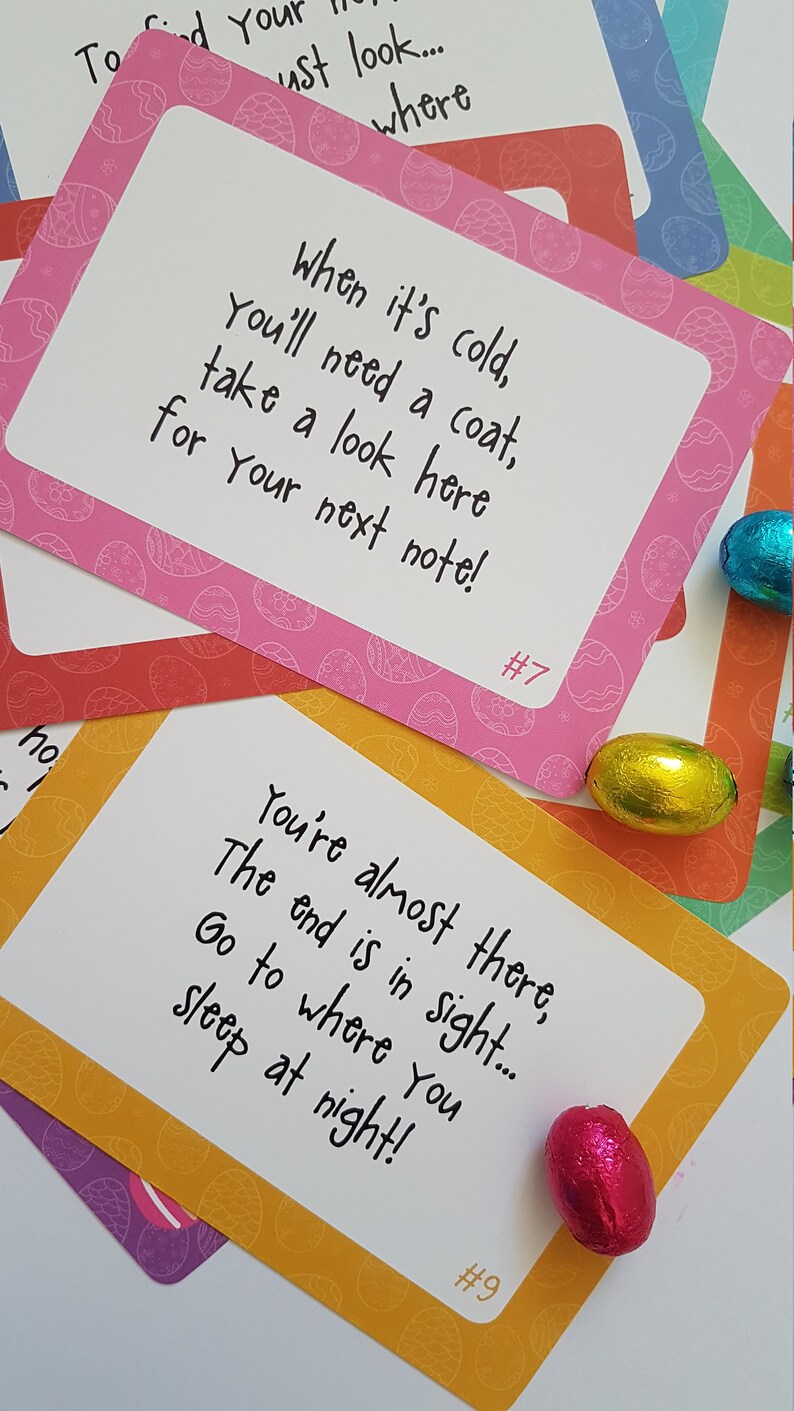 May include: A set of nine Easter egg hunt clue cards with a pink, orange, yellow, and green background. Each card has a different number and a clue written on it. The clues are: "When it's cold, you'll need a coat, take a look here for your next note!" and "You're almost there, the end is in sight... Go to where you sleep at night!"