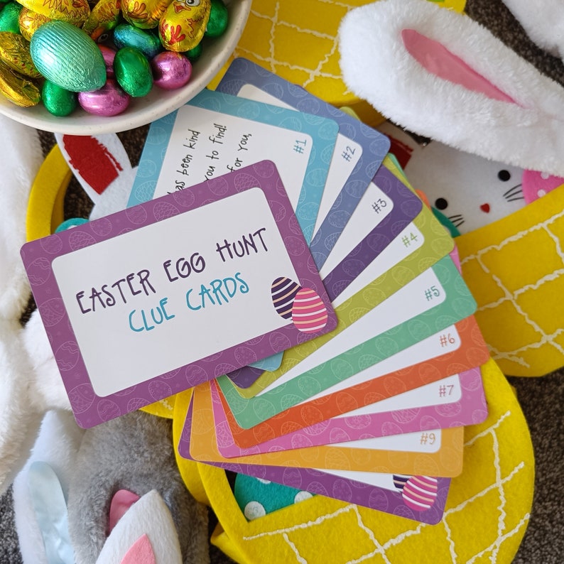 May include: A set of nine colorful Easter egg hunt clue cards with the text "Easter Egg Hunt Clue Cards" on the top card. The cards are numbered 1 through 9.