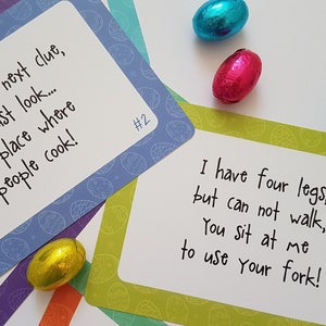 May include: Four colorful cards with handwritten clues for an Easter egg hunt. The cards are decorated with a pattern of blue and white eggs. The text on the cards reads: "To find your next clue, you must look... in a place where people cook!" and "I have four legs, but can not walk, you sit at me to use your fork!"