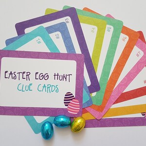 May include: A set of nine colorful Easter egg hunt clue cards with a purple card in the front that says "Easter Egg Hunt Clue Cards".